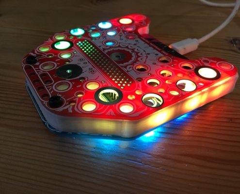 A red glowing lantern made of 3D printed materials an printed circuit boards, with a USB cable connection.