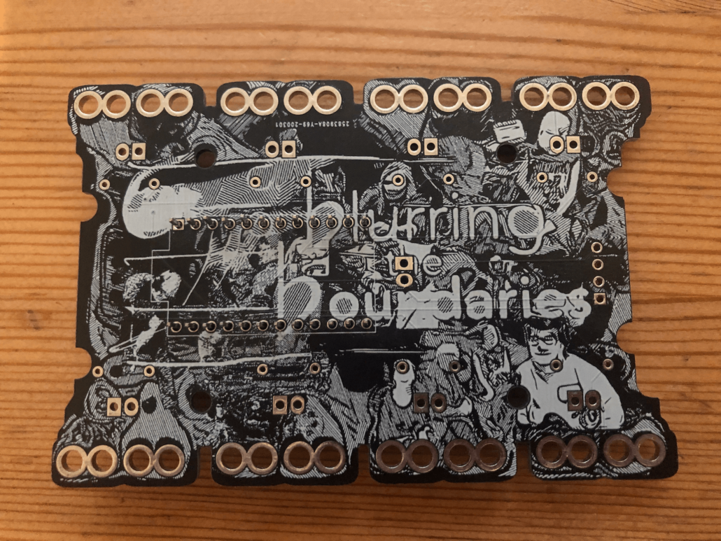 A black and white circuit board features flowing line art of artists' faces merging with abstract shapes, with the blurring the boundaries logo at the centre. Around the edges of the board are eight sets of two "figure of eight" shaped holes to accomodate crocodile clips.